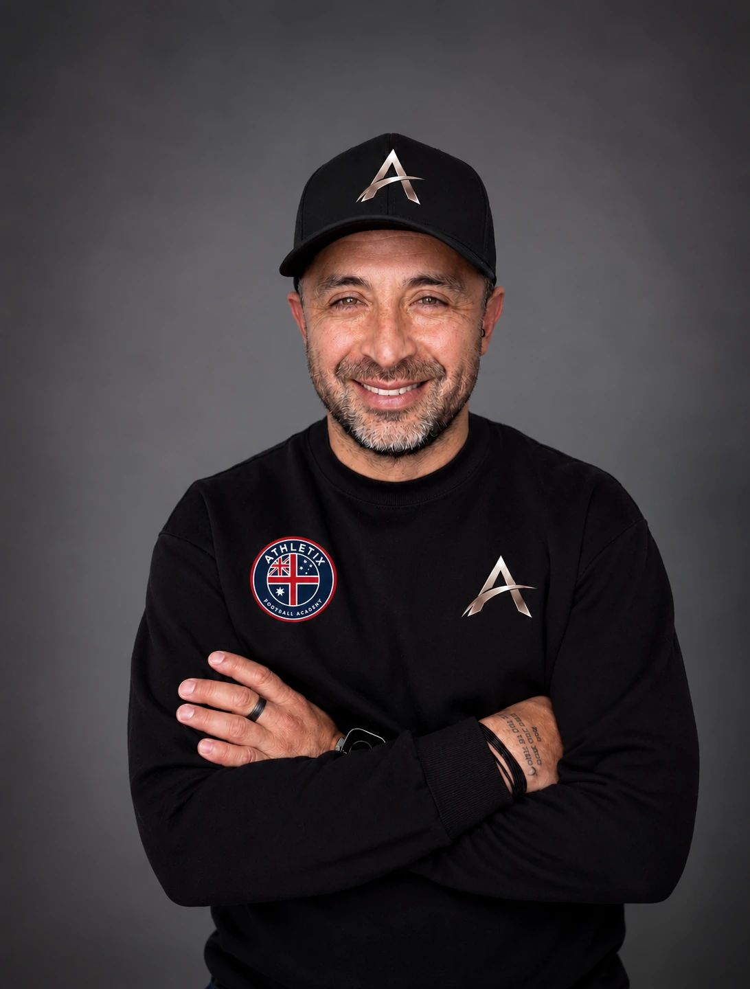Coach Julio in his ATHLETIX cap and sweatshirt